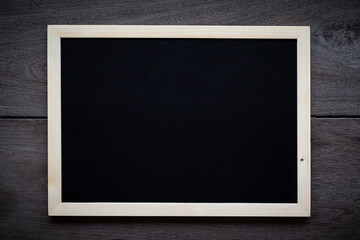 empty Blank chalkboard in wooden frame isolated on wooden background