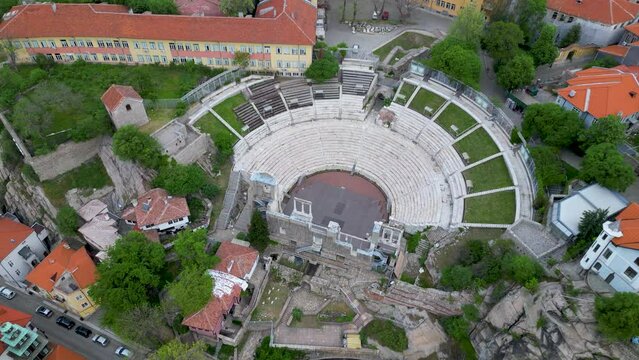 Aerial shot of the city center of Plovdiv with the Ancient Theatre of Plovdiv. Antique roman showplace seen from high above. The central post office and neighbourhoods of Philippopolis in the balkans.