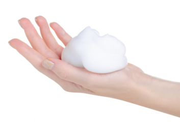 White foam mousse on hand on white background isolation