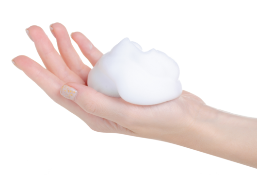 White foam mousse on hand on white background isolation