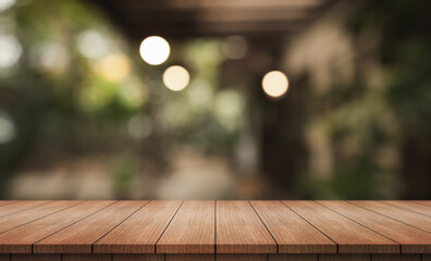 Empty wooden table top with lights bokeh on blur restaurant background.