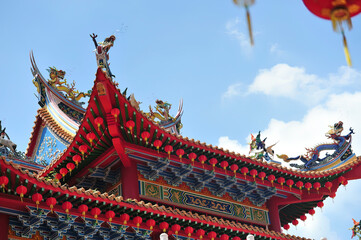 golden dragon sculpture red lanterns on traditional chinese roof