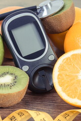 Glucometer for checking sugar level and fresh fruits. Source natural minerals and vitamins