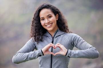 Athlete, heart hands or portrait of happy woman in park for running exercise or workout for body...