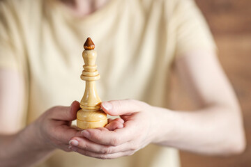 game of chess. Chess pieces in a woman's hand.