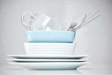 Clean dishes, table and plate pile in studio for lunch isolated on white background in kitchen....