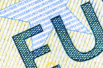 Macro image of fragment of one hundred Euro banknote. Close up EU description. Horizontal image.