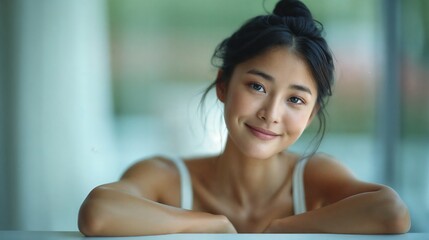 Serene Asian Woman with Relaxed Bun Hairstyle, Perfect for Spa and Wellness Advertising
