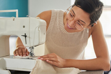 Smile, woman and sewing machine in apartment for small business, fashion design and pride. Female...