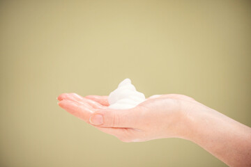 Disinfectant foam in hands for hand hygiene, prevention of coronavirus virus. Gentle Hand Skin Care.