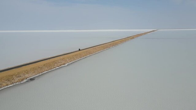 Aerial drone footage of a bike riding in road to heaven in dholavera in gujrat