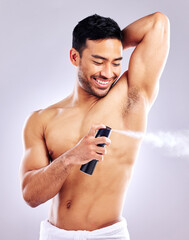 Man, grooming armpit and smile with deodorant in studio background for hygiene, cleanliness and wellness. Male person, happy and confident with body spray for odor, fragrance and fresh scent