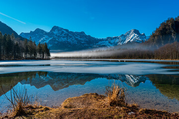 Tranquil Morning at Almsee with Mountain Reflection and Morning Mist