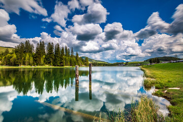 Serene Teichalm Lake in Styria with Clear Reflection and Cloudy Sky