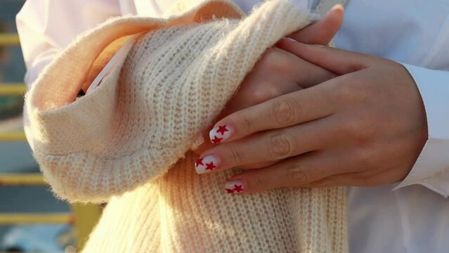 Girl hands close-up, girl holding white jacket