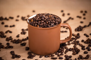 many macro aromatic coffee beans in a cup  on the background.