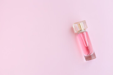 Perfume bottle on pink background, Glass bottle of perfumery
