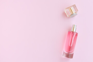Perfume bottle on pink background, Glass bottle of perfumery