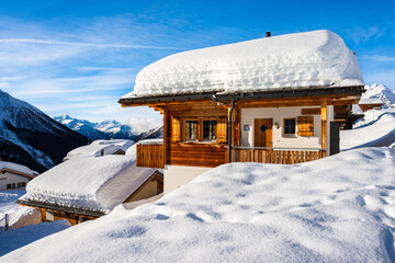 Traditional alpine wooden house in winter mountain snow landscape, Loetschental valley, Switzerland