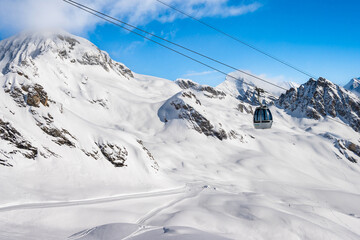 Ski gondola in alpine mountain resort on sunny day, Loetschental valley, Switzerland