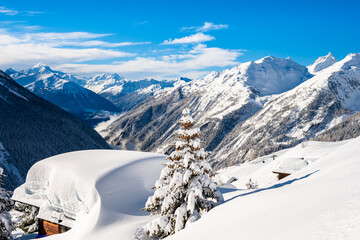 Traditional alpine wooden house in winter mountain snow landscape, Loetschental valley, Switzerland