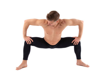 Sports and healthy lifestyle. An attractive man is doing yoga and pilates. White background.