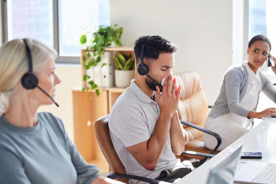Man, sick and coworkers in call centre office or blowing nose with unhappy colleagues, telemarketing or flu. Male person, headset and customer service or with cold symptoms, contagious or illness