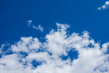 White clouds on a blue sky as a background.