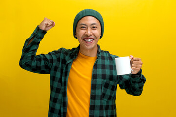 An excited young Asian man, dressed in a beanie hat and casual shirt, is enthusiastically making a...