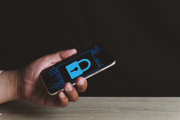 Hand holding smartphone with data protection icon, virtual screen interfaces.,Cybersecurity and privacy concept