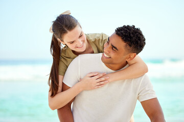Obraz premium Hug, piggyback and smile of couple at beach together for holiday, travel or vacation in summer. Happy, love or romance with man and woman outdoor by ocean or sea for coastal and tropical getaway