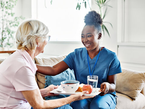 nurse senior woman home care patient elderly lunch caregiver meal food hospital eating eat recovery health retirement assistance nursing old support reaching out