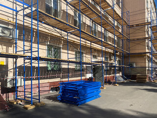 Temporary scaffolding frame construction assembled around buildings. Local home renovation concept....