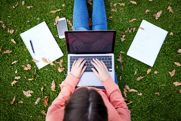 Student, laptop and notebook on grass for learning, research and studying on campus. Woman, computer and typing outdoors at university for elearning, networking and online education from above