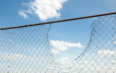 Broken metal mesh fence