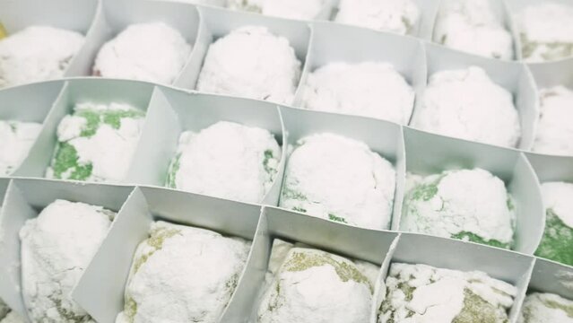 Mochi variants of various colors and flavors such as Pandan, Chocolate, Moca, Milk, Cheese. Mochi is made from sticky rice which is finely ground and then shaped into rounds and flavored