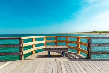 bench on wooden passage over a ocean. construction on Pier, Seebrücke Graal Müritz, Ostsee,...