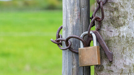 Padlock with chain on the fence.