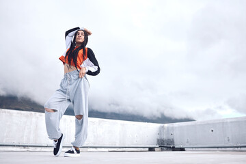 Woman, hip hop and outdoor fashion in city for freedom with streetwear, style inspiration and...