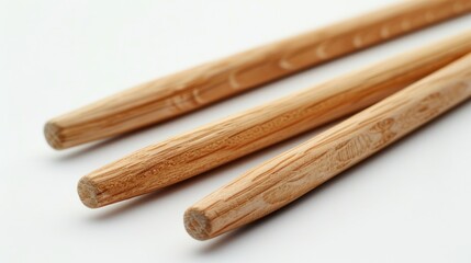 Close up shot of drumsticks on a crisp white background with ample space for text