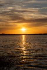 beautiful sky and reflection of the sun and sky in the lake water