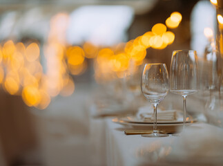 Luxury table settings for fine dining with and glassware, beautiful blurred background. Preparation for holiday Christmas