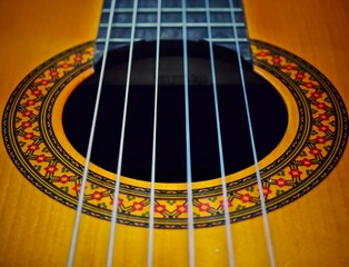 Obraz premium an ornately decorated guitar strings and body in red, yellow, orange, and