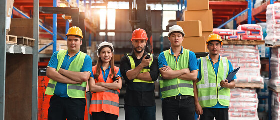 Portrait of Smart and Confident Multiracial Warehouse Workers in safety wear standing in a line,...
