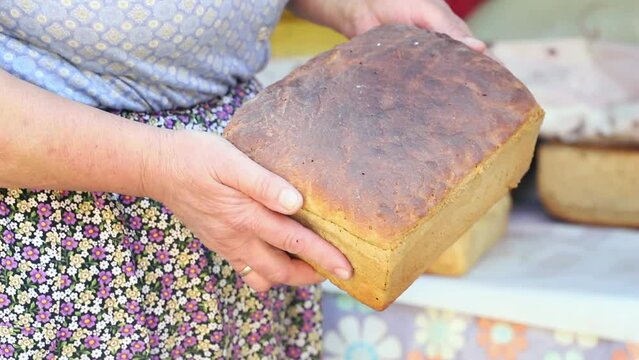 Turkish peasant woman prepares traditional bread in a wood-fired tal oven.