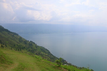 Stunning scenery of volcanic lake Toba - largest and deepest crater lake in the world located in...