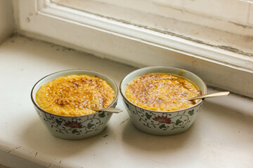 two Chinese bowls of millet porridge on the windowsill