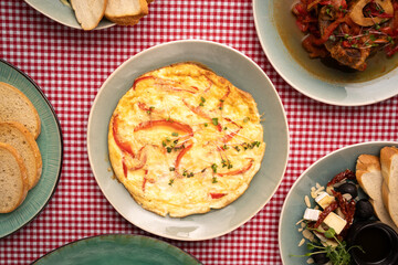 Omelette with red bell pepper on table. Healthy diet food for breakfast.