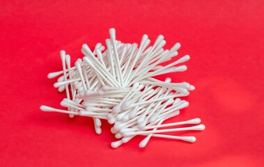 Cotton Buds or Cotton Swab Heap Isolated on Red Background with Copy Space
