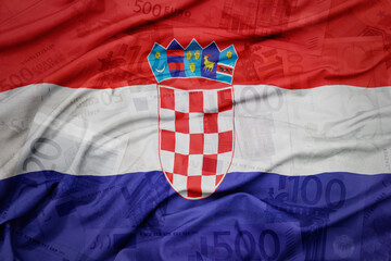 waving colorful national flag of croatia on a euro money banknotes background. finance concept.